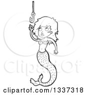 Lineart Clipart Of A Cartoon Black And White Mermaid Reaching For A Hook Royalty Free Outline Vector Illustration by lineartestpilot