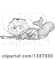 Lineart Clipart Of A Cartoon Black And White Tattooed Mermaid Swimming Royalty Free Outline Vector Illustration