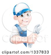 Clipart Of A Happy Young Brunette Caucasian Mechanic Man In Blue Wearing A Baseball Cap Holding An Adjustable Wrench Around A Sign Royalty Free Vector Illustration
