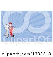 Clipart Of A Cartoon White Male Mechanic Leaning On A Giant Wrench And Blue Rays Background Or Business Card Design Royalty Free Illustration