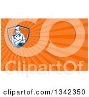 Clipart Of A Retro Male Mechanic Holding A Wrench In Folded Arms In A Shield And Orange Rays Background Or Business Card Design Royalty Free Illustration