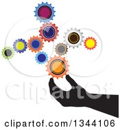 Poster, Art Print Of Black Silhouetted Hand Creating Something With Colorful Gear Cog Wheels