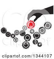 Poster, Art Print Of Black Silhouetted Hand Creating Something With Black And Red Gear Cog Wheels
