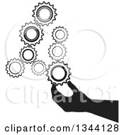 Clipart Of A Black Silhouetted Hand Inserting A Gear Cog Wheel Royalty Free Vector Illustration by ColorMagic #COLLC1344128-0187
