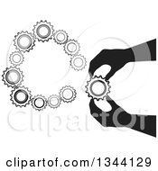 Poster, Art Print Of Black Silhouetted Hand Inserting A Gear Cog Wheel 2
