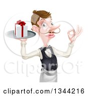 Cartoon Caucasian Male Waiter With A Curling Mustache Holding A Gift On A Platter And Gesturing Ok