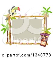 Toucan Bird Perched On A Topical Sign With A Tiki Statue And Palm Trees