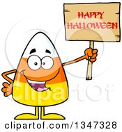 Cartoon Candy Corn Character Holding Up A Happy Halloween Greeting Wooden Sign