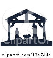 Navy Blue Silhouetted Mary And Joseph Praying Over Baby Jesus In A Manger