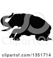 Clipart Of A Black Silhouetted Elephant Getting Up Royalty Free Vector Illustration