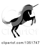 Poster, Art Print Of Black Silhouetted Rearing Rampant Unicorn In Profile Facing Right