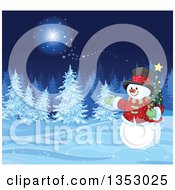 Christmas Snowman Holding A Small Tree And Presenting A Winter Forest At Night With Snow Flocked Evergreens And Magic