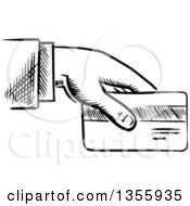 Clipart Of A Black And White Sketched Business Mans Hand Holding A Credit Card Royalty Free Vector Illustration by Vector Tradition SM