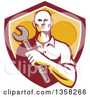 Clipart Of A Retro Male Mechanic Holding A Giant Wrench Over His Chest In A Shield Royalty Free Vector Illustration
