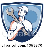 Poster, Art Print Of Retro Male Mechanic Holding A Giant Wrench Over His Shoulder In A Blue And White Shield