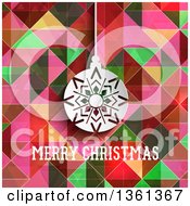 Clipart Of A White Paper Snowflake Bauble Over Merry Christmas Text And Colorful Geometric Royalty Free Vector Illustration
