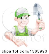 Poster, Art Print Of Happy Young Brunette White Male Gardener In Green Pointing Down Over A Sign And Holding A Shovel