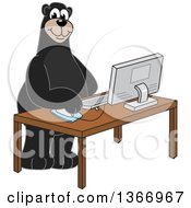 Black Bear School Mascot Character Using A Desktop Computer