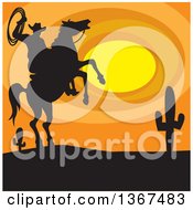 Silhouetted Horseback Cowboy Holding A Rope On A Rearing Horse Against A Desert Sunset