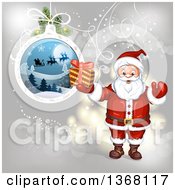 Poster, Art Print Of Suspended Christmas Bauble And Santa Holding A Gift
