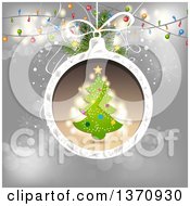 Poster, Art Print Of Tree In A Christmas Bauble Frame Over Gray With Lights