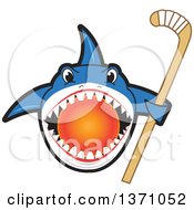 Shark School Mascot Character Biting A Hockey Ball And Holding A Stick