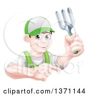 Young Brunette White Male Gardener In Green Holding A Garden Fork And Pointing Over A Sign