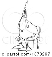Clipart Of A Cartoon Black And White Dog Wearing A Dunce Hat And Sitting In A Chair Royalty Free Vector Illustration