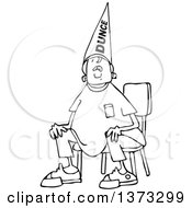 Clipart Of A Cartoon Black And White Boy Wearing A Dunce Hat And Sitting In A Chair Royalty Free Vector Illustration
