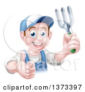 Happy Young Brunette White Male Gardener In Blue Holding A Garden Fork And Thumb Up Over A Sign