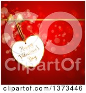 Clipart Of A Happy Valentines Day Greeting Heart Shaped Tag With A Gold Bow And Ribbon Over Red With Flares Royalty Free Vector Illustration
