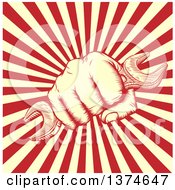 Clipart Of A Retro Woodcut Fist Holding A Wrench Over A Burst Of Red And Tay Rays Royalty Free Vector Illustration