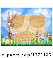 Clipart Of A Brown Bunny Rabbit With Eggs And An Easter Basket Pointing Around A Blank Wood Sign Against Sky Royalty Free Vector Illustration