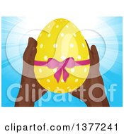 Poster, Art Print Of Pair Of Black Hands Holding Up A 3d Yellow Polka Dot Easter Egg With A Pink Bow