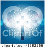 Glowing Cross With A Starry Light Burst And Flares On Blue