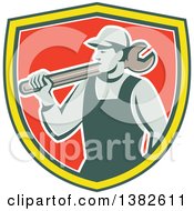 Clipart Of A Retro Male Mechanic Holding A Giant Wrench Over His Shoulder In A Green Yellow White And Red Shield Royalty Free Vector Illustration