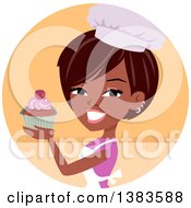 Pretty Black Baker Woman Holding Up A Cupcake