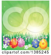 Poster, Art Print Of Background Of Patterned Easter Eggs Grass And Flowers Against A Green Sky With Sunshine
