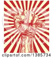 Clipart Of A Retro Woodcut Or Engraved Fisted Hand Holding A Pencil Over Rays Royalty Free Vector Illustration by AtStockIllustration
