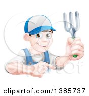 Young Brunette White Male Gardener In Blue Holding A Garden Fork And Pointing Over A Sign