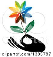 Poster, Art Print Of Black Silhouetted Hand Holding A Colorful Flower