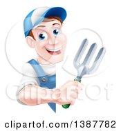 Happy Middle Aged Brunette White Male Gardener In Blue Holding A Garden Fork Around A Sign