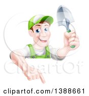 Poster, Art Print Of Happy Middle Aged Brunette White Male Gardener In Green Pointing Down Over A Sign And Holding A Shovel