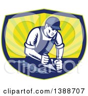 Clipart Of A Retro Woodcut Carpenter Wearing A Hat And Overalls Working With A Smooth Plane On A Wood Surface In A Blue Green And Yellow Shield Royalty Free Vector Illustration by patrimonio
