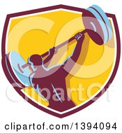 Clipart Of A Retro Male Bodybuilder Swinging A Barbell In A Shield Royalty Free Vector Illustration
