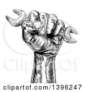 Clipart Of A Retro Black And White Woodcut Or Engraved Fisted Hand Holding Up A Spanner Wrench Royalty Free Vector Illustration