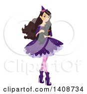 Caucasian Teenage Girl In A Witch Costume Holding A Cat