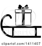Clipart Of A Black And White Sled And Christmas Gift Icon Royalty Free Vector Illustration