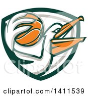 Clipart Of A Retro Pelican Bird Holding A Basketball In A Green White And Gray Shield Royalty Free Vector Illustration