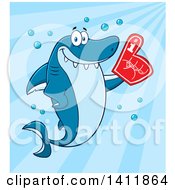 Cartoon Happy Shark Mascot Character Wearing A Foam Finger Over Blue